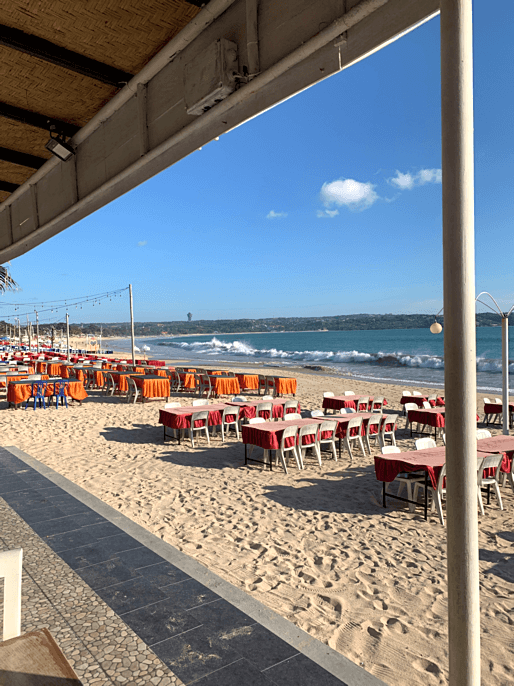 Sonnenuntergang mit Strandrestaurants am Jimbaran Beach in Bali